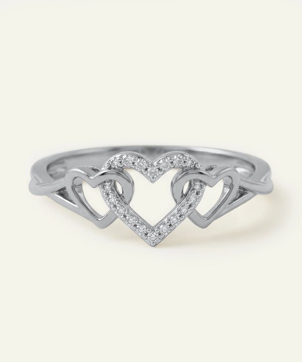 Silver ring with a heart design on a white background