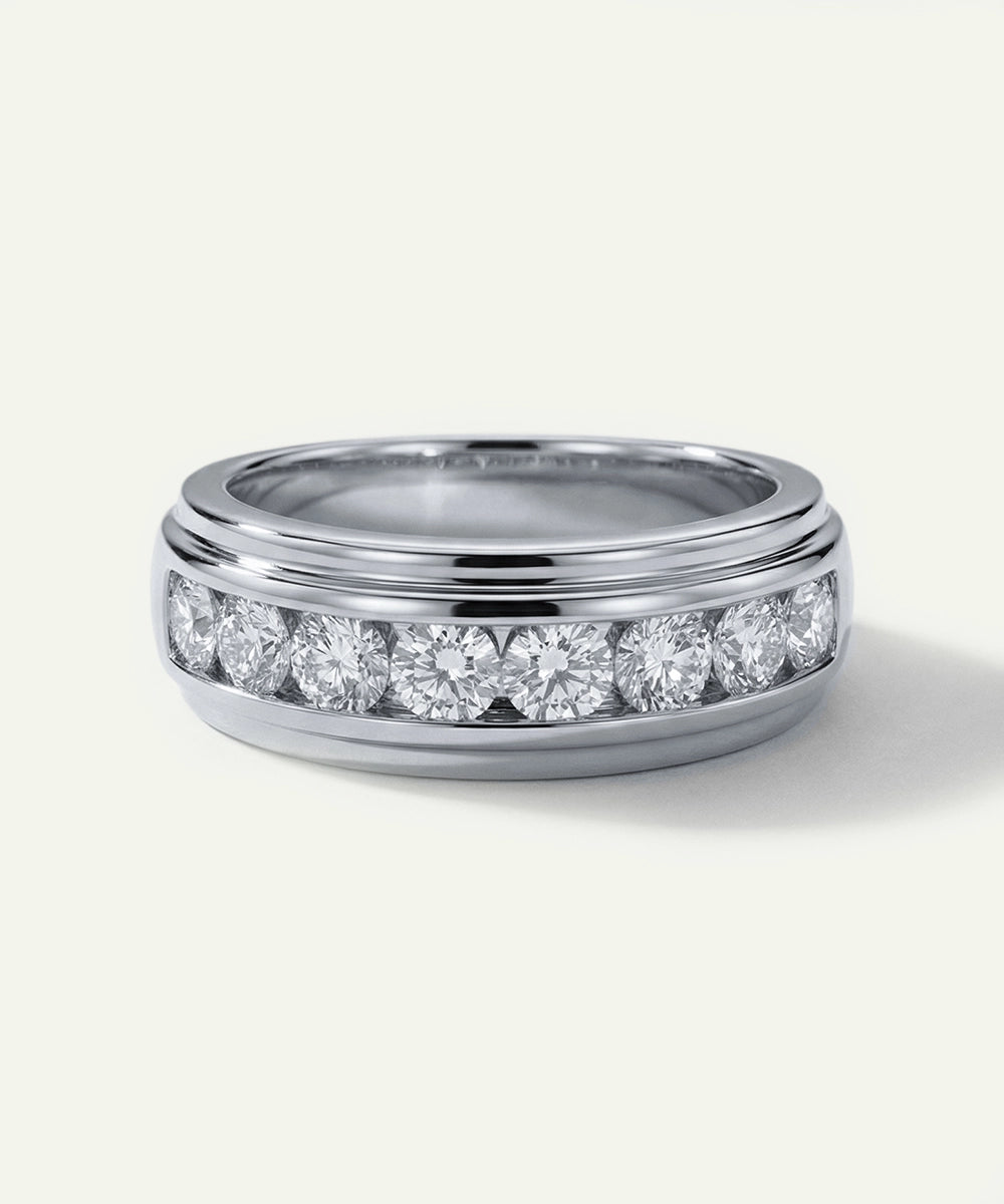 Silver ring with embedded diamonds on a white background