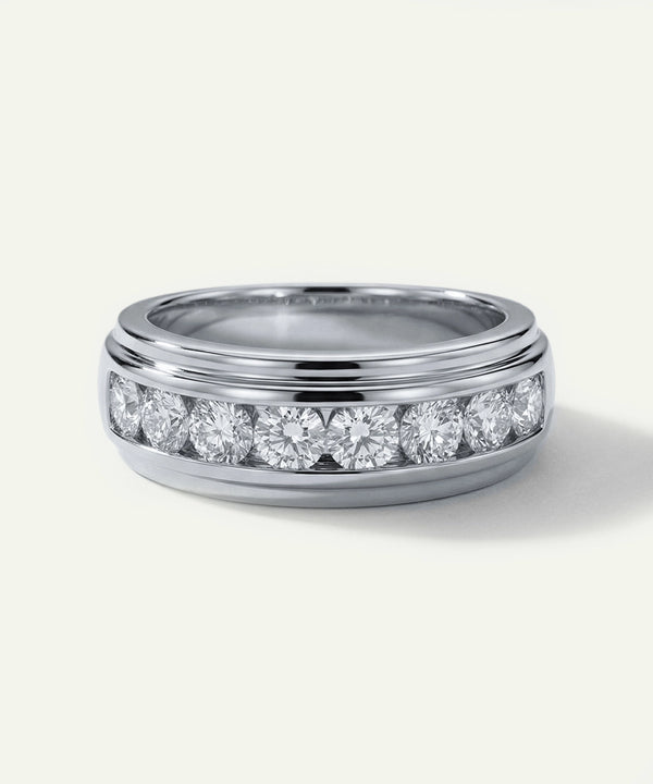 Silver ring with embedded diamonds on a white background
