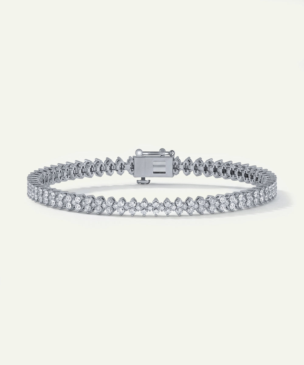 Silver bracelet with clear stones on a white background