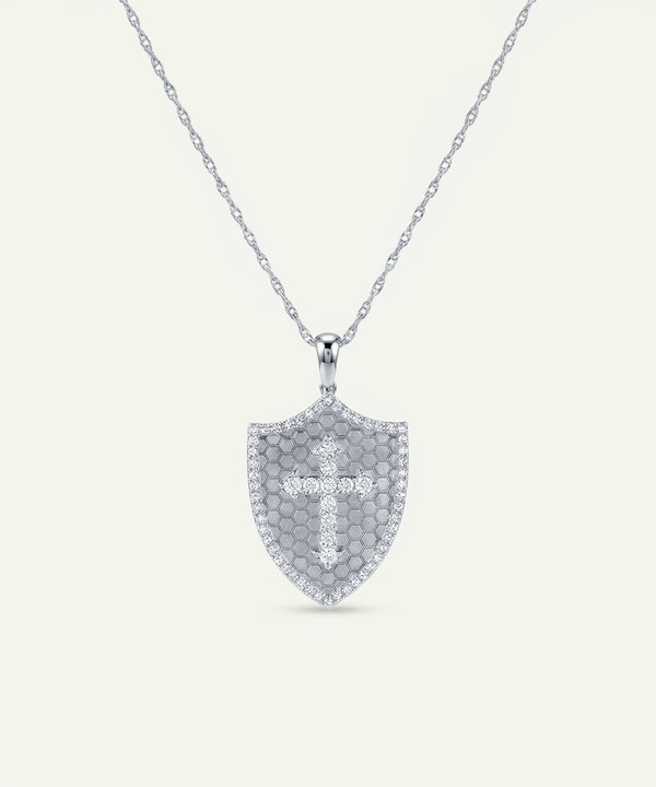 Silver necklace with a shield-shaped pendant on a light gray background