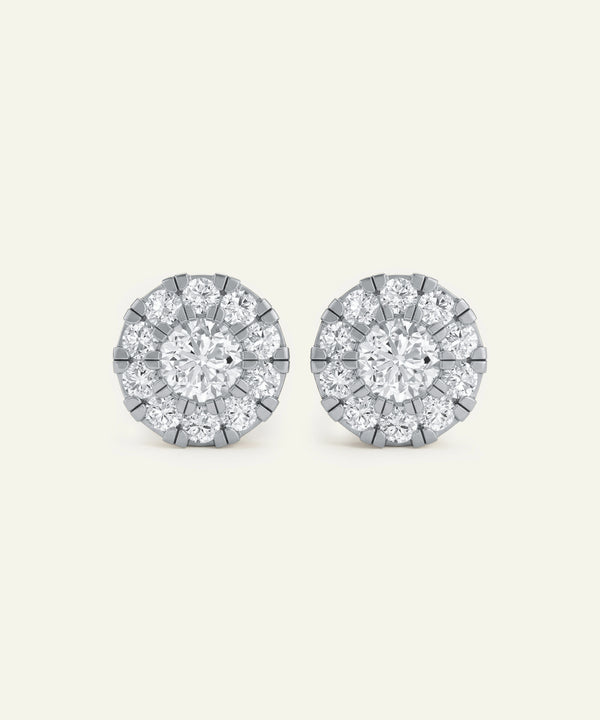 Pair of diamond stud earrings on a light gray background