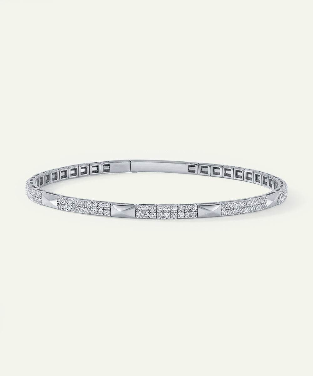 Silver bracelet with diamond accents on a white background