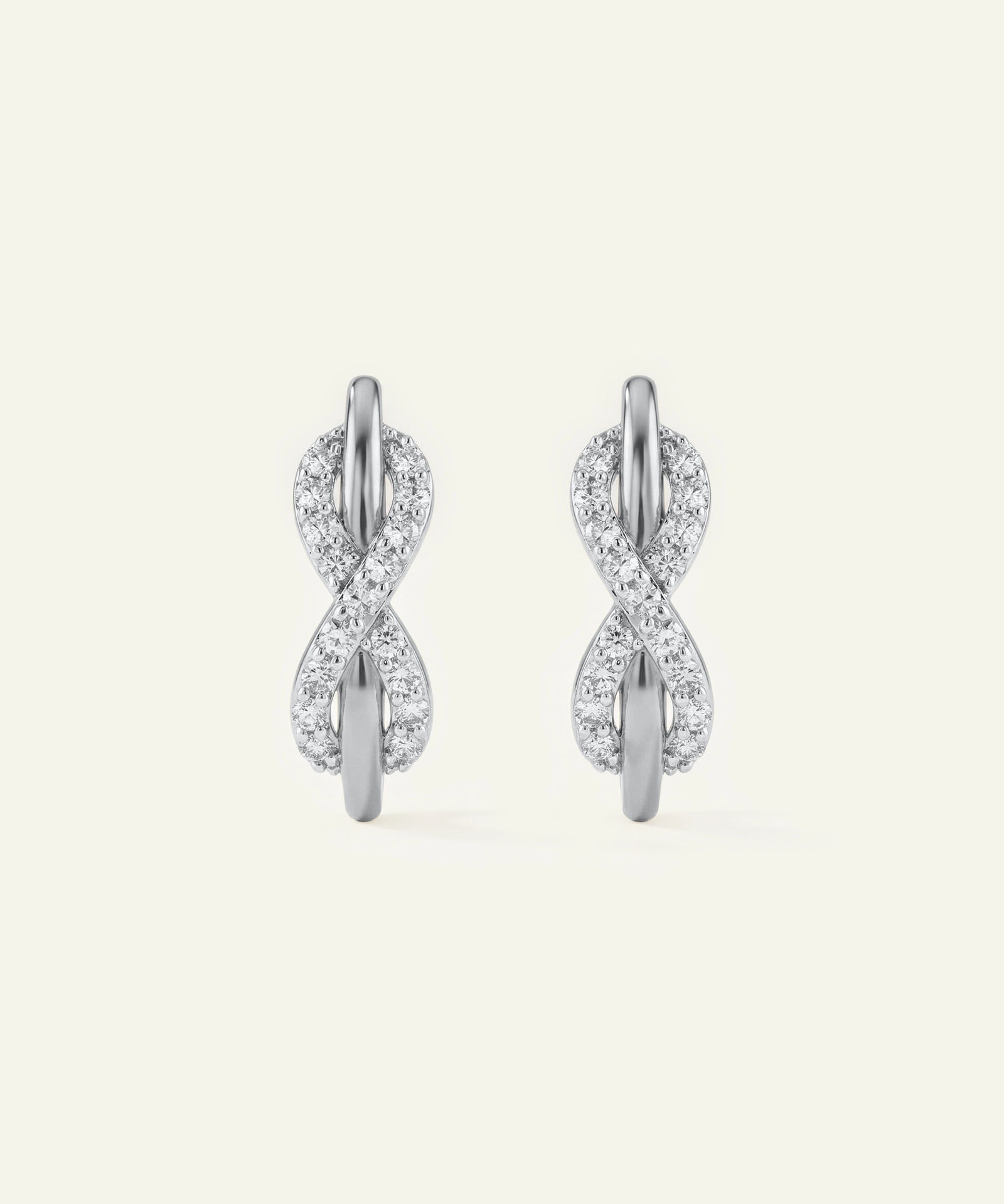 Pair of silver earrings with diamond accents on a white background
