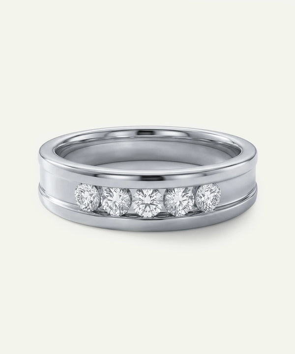 Silver ring with embedded diamonds on a white background