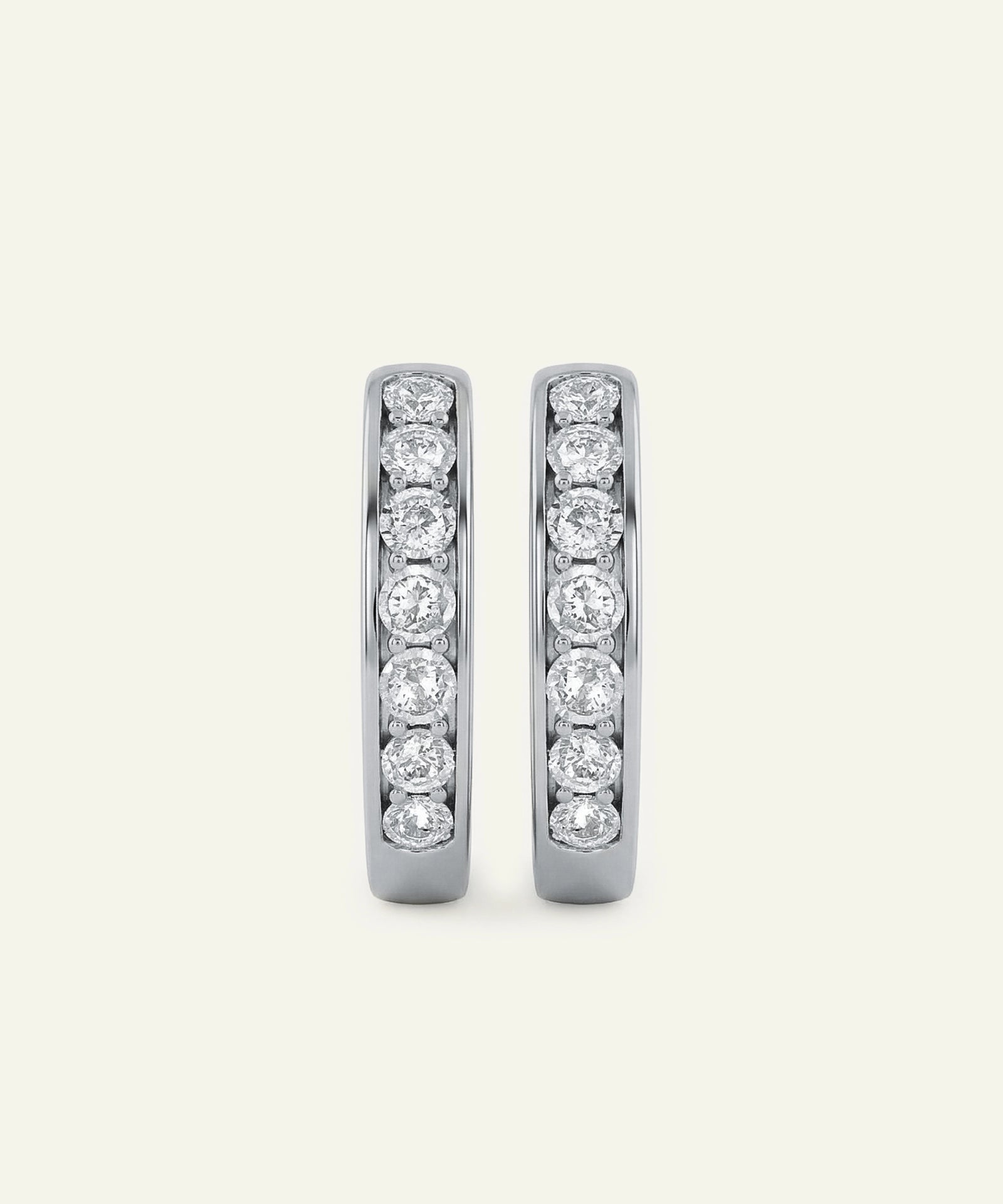 Pair of diamond hoop earrings on a light gray background