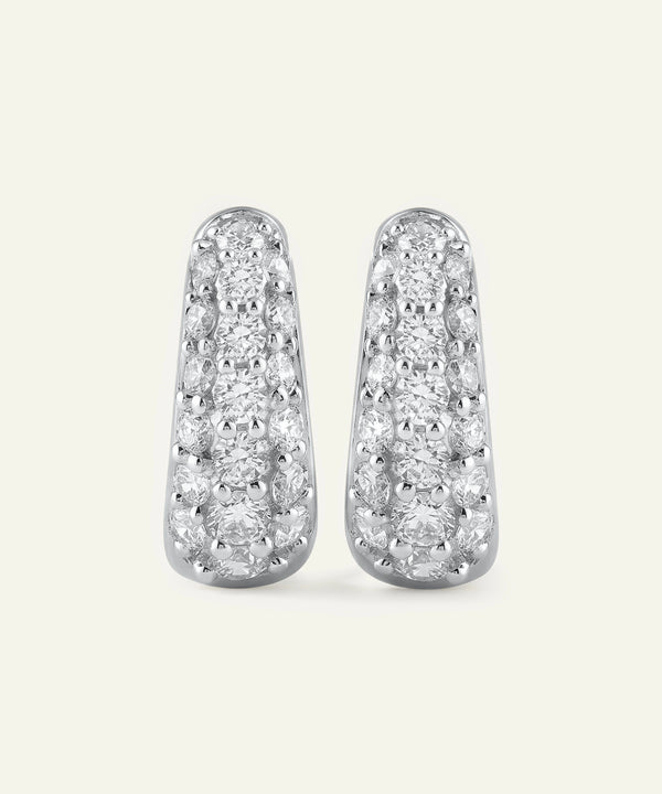 Pair of diamond earrings on a light gray background