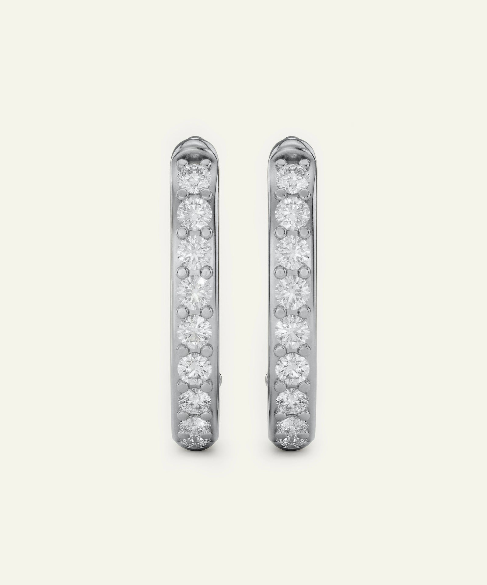 Pair of diamond earrings on a light gray background