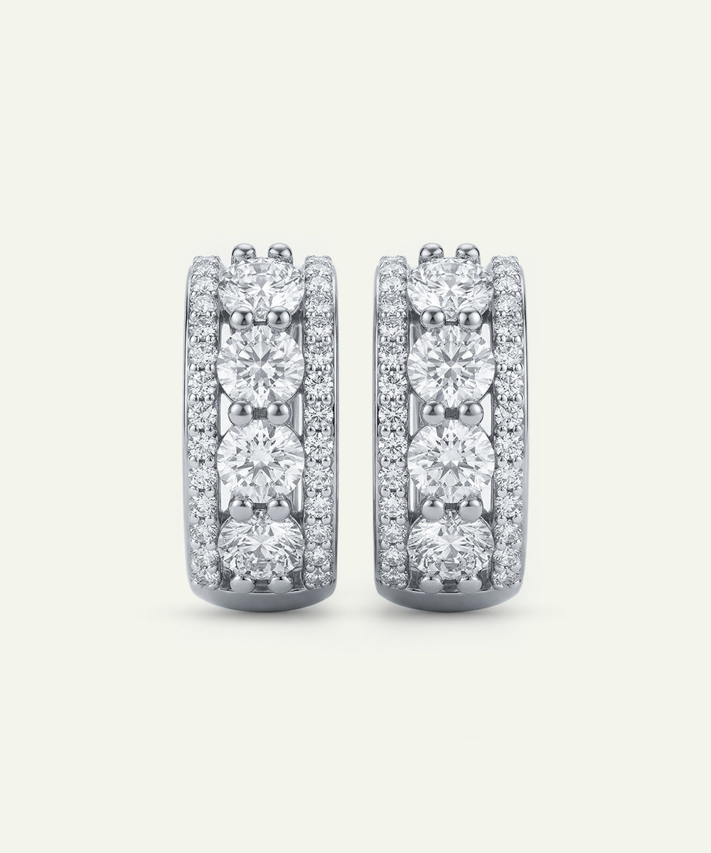 Pair of diamond earrings on a light gray background