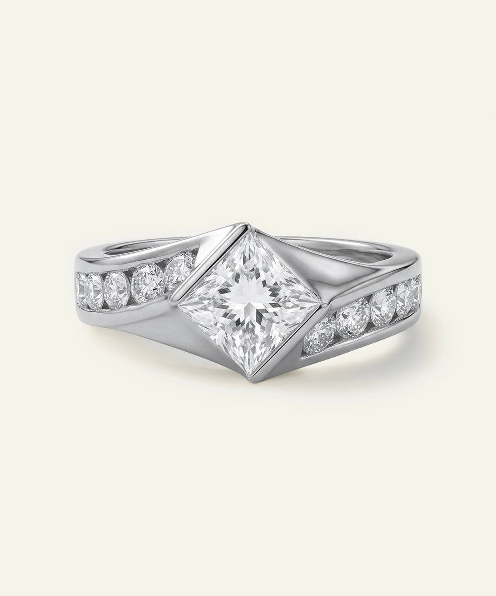 Silver ring with diamond accents on a light gray background