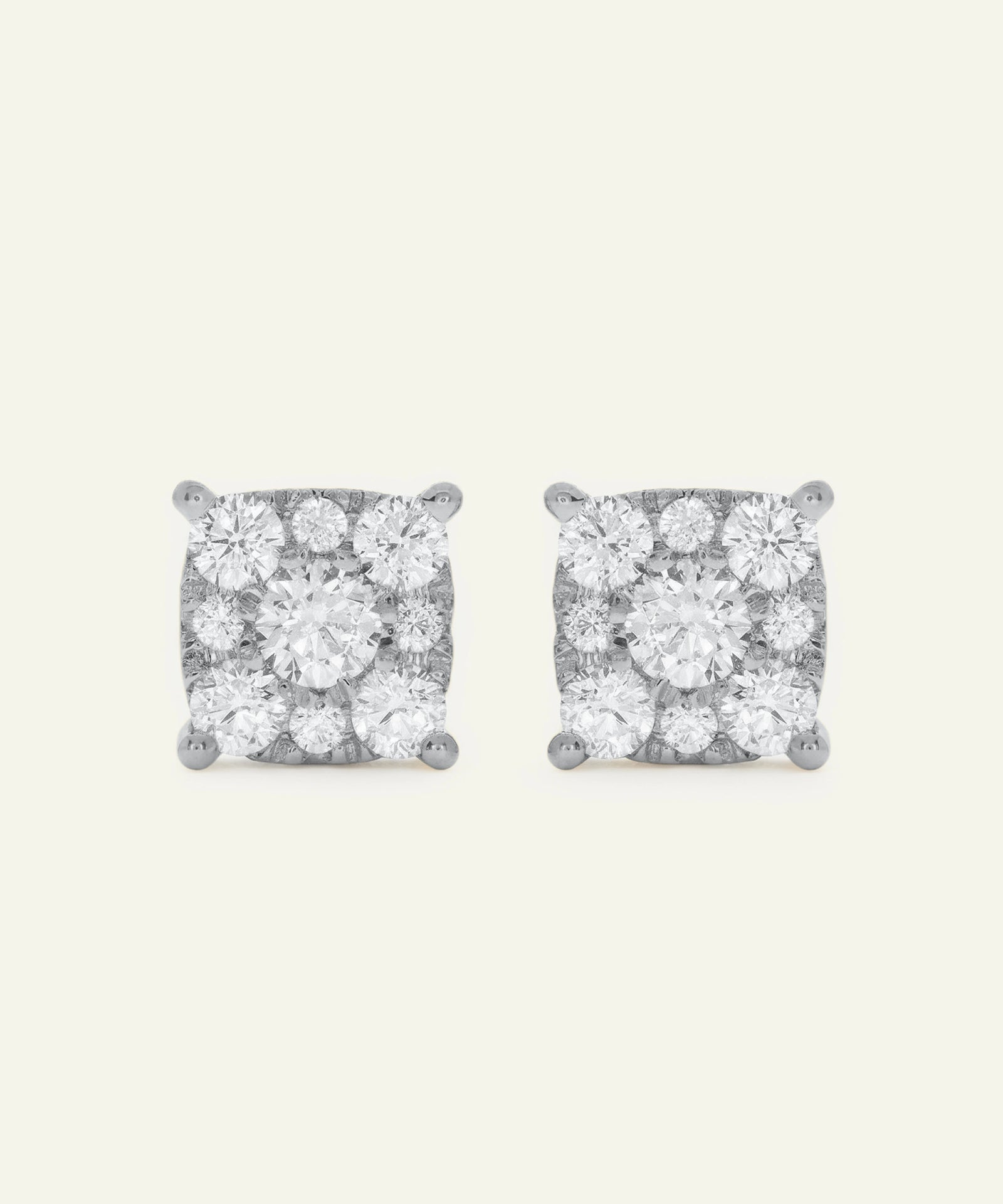 Pair of diamond stud earrings on a light gray background