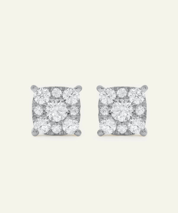 Pair of diamond stud earrings on a light gray background