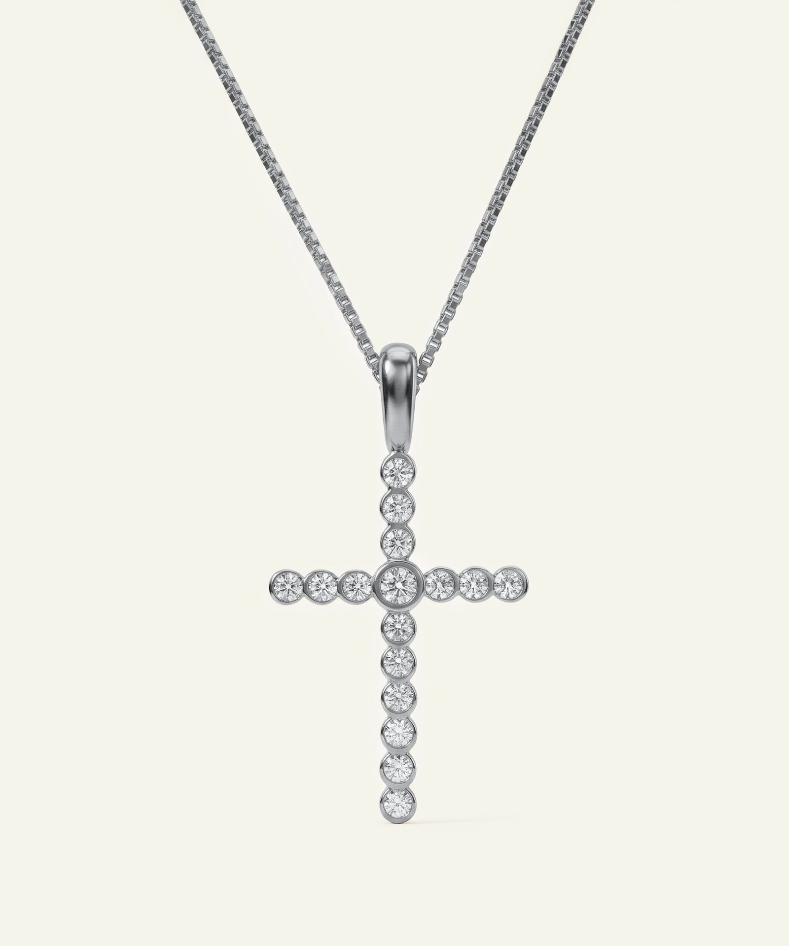 Silver cross pendant necklace on a white background