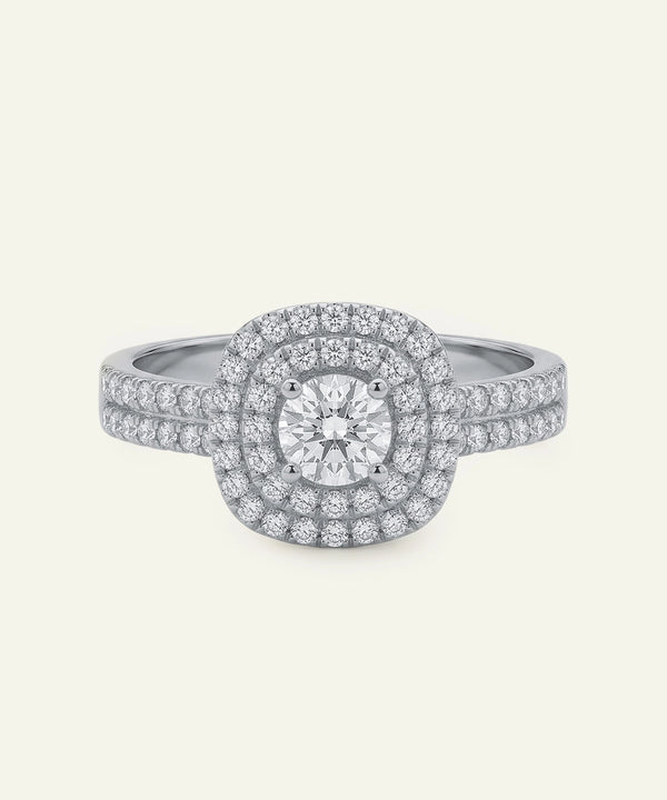 Diamond ring with a double halo on a light gray background