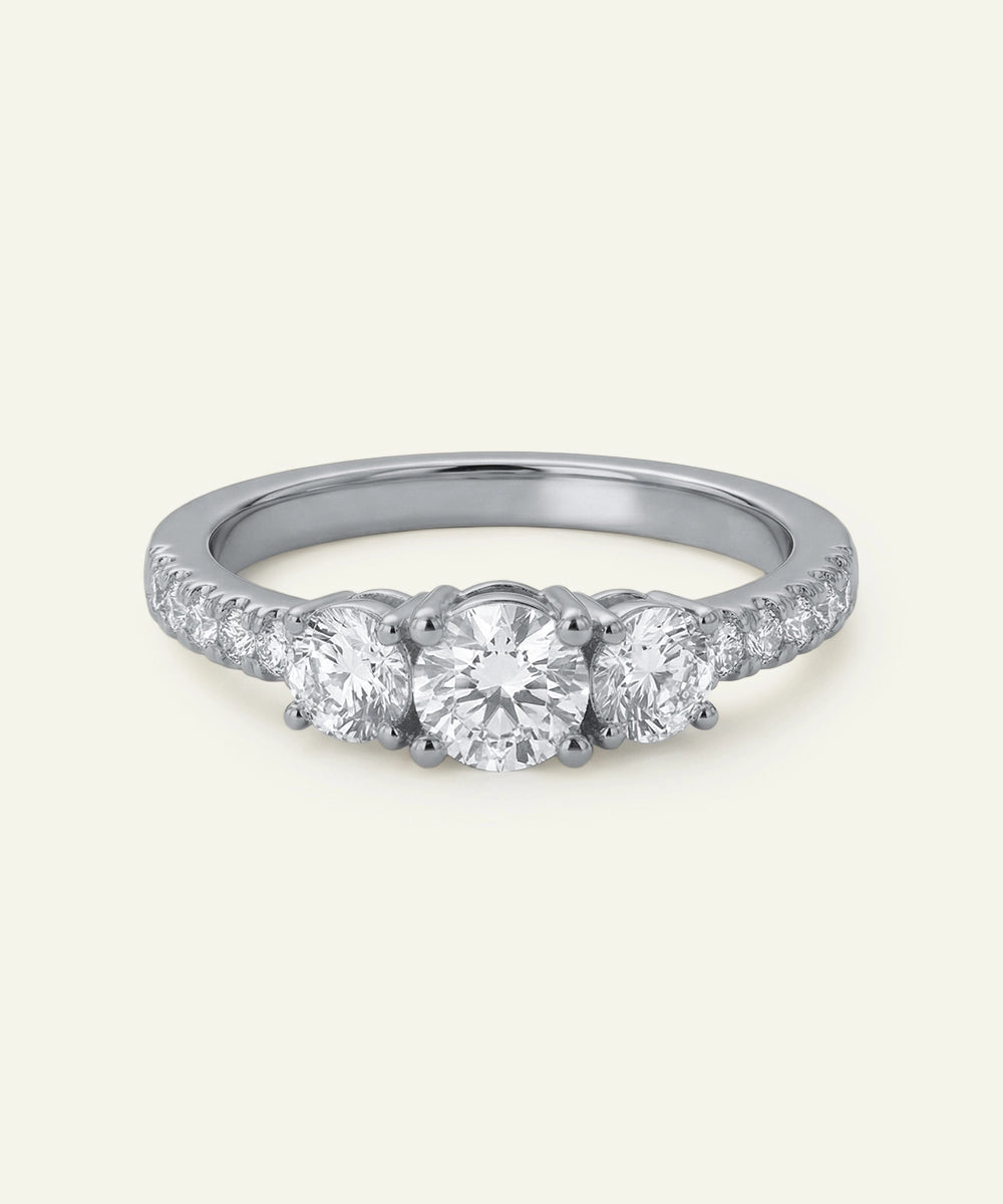 Silver ring with three diamonds on a white background