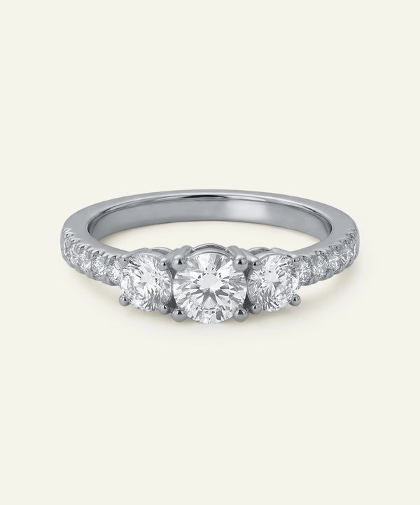Silver ring with three diamonds on a white background