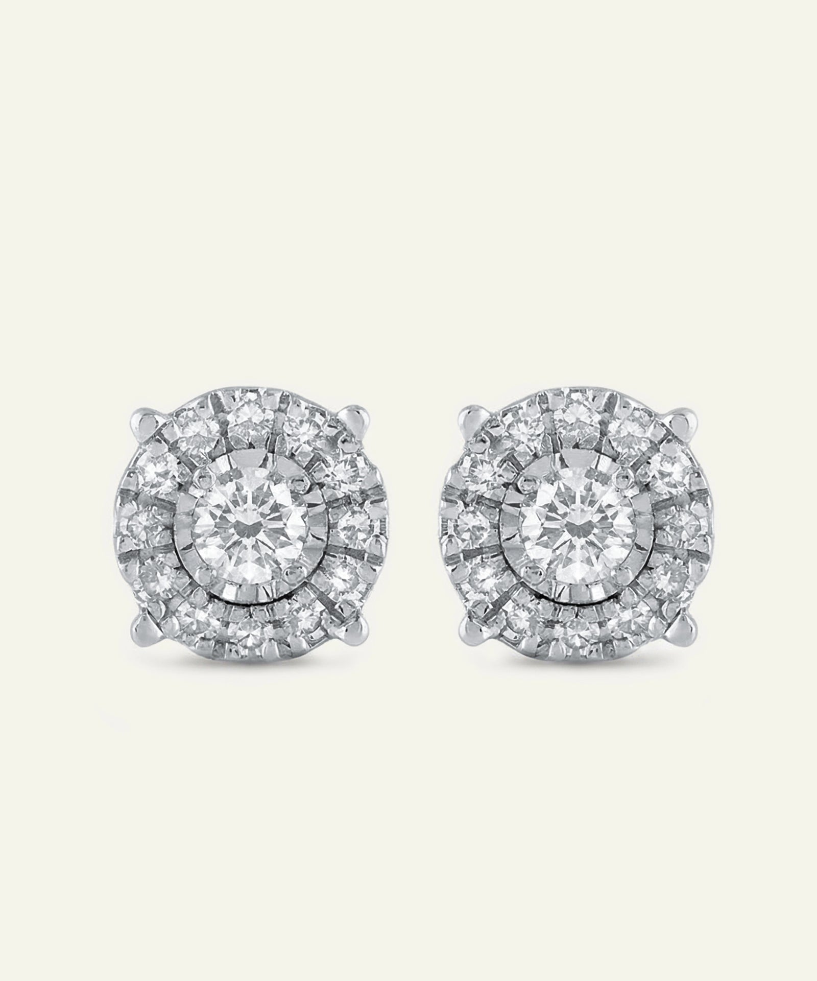 Pair of diamond stud earrings on a light gray background