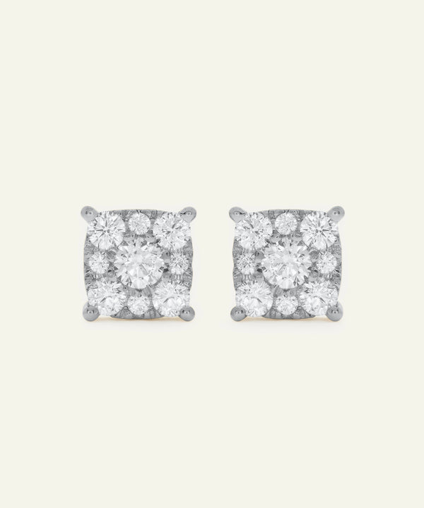 Pair of diamond stud earrings on a light gray background