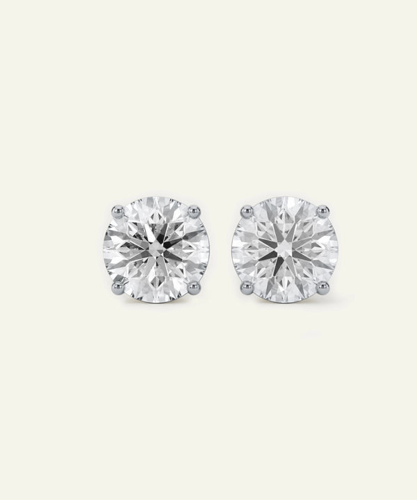 Pair of diamond stud earrings on a white background