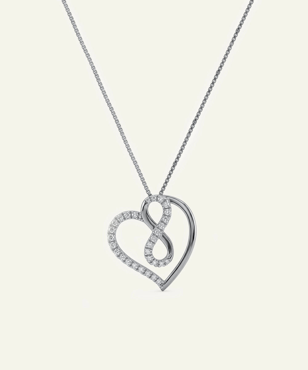 Silver heart-shaped pendant necklace on a light gray background