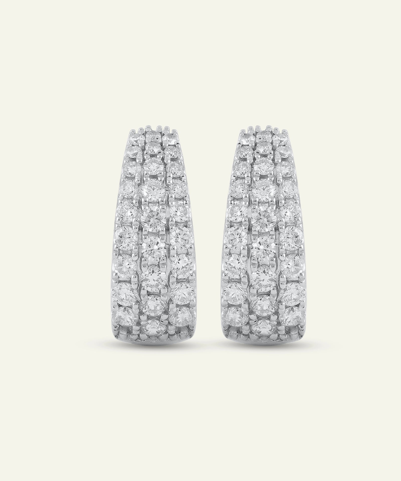 Pair of diamond earrings on a light gray background