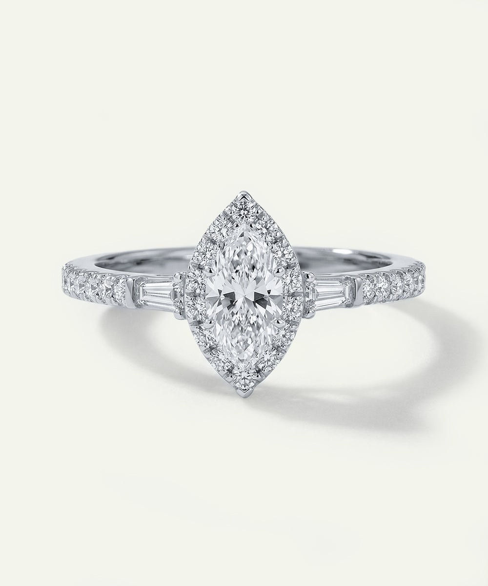 Diamond ring with a marquise-shaped center stone on a white background