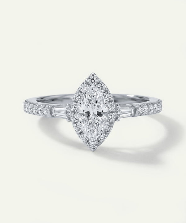 Diamond ring with a marquise-shaped center stone on a white background