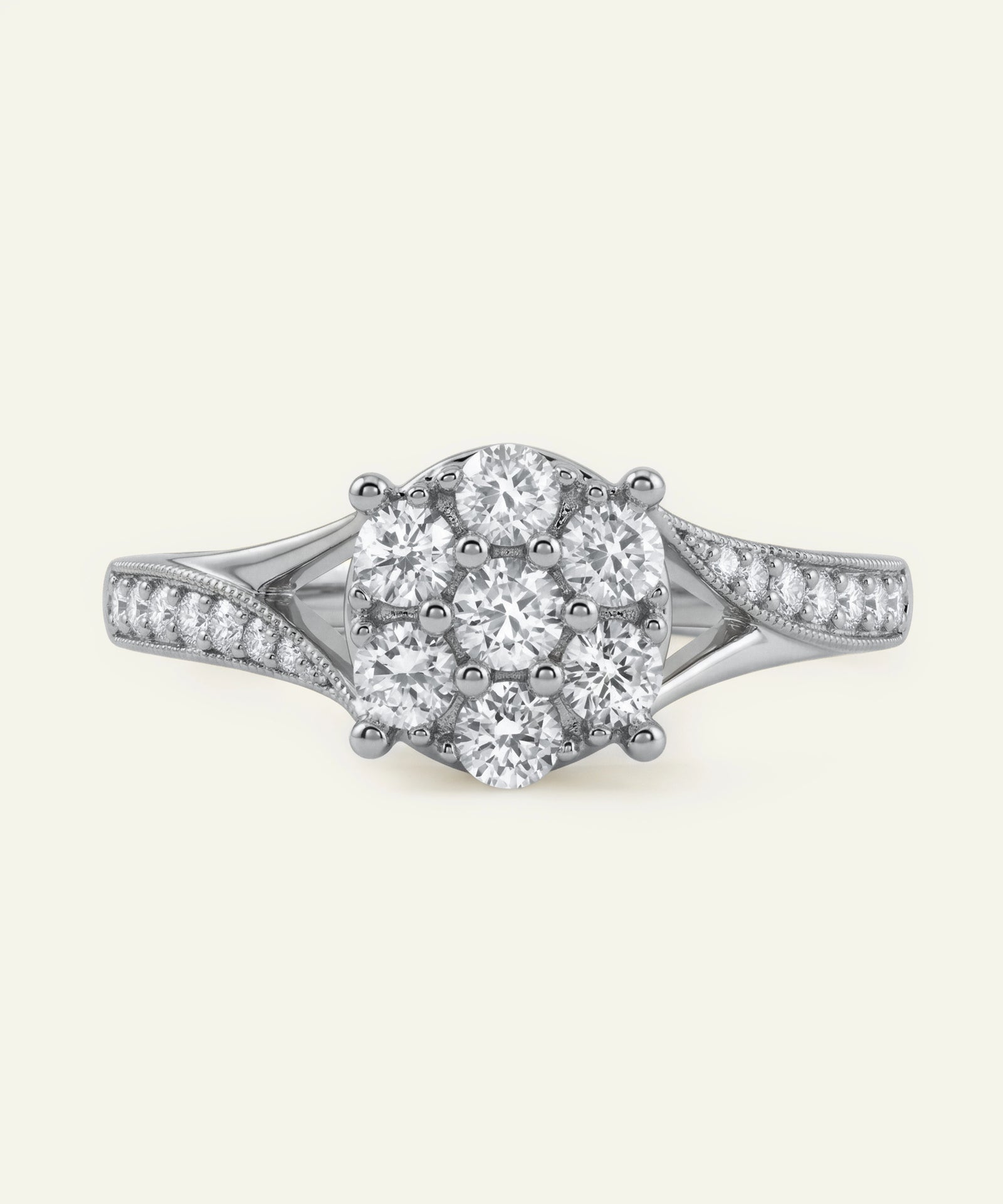 Diamond ring with a central oval-shaped diamond and smaller diamonds on a white background