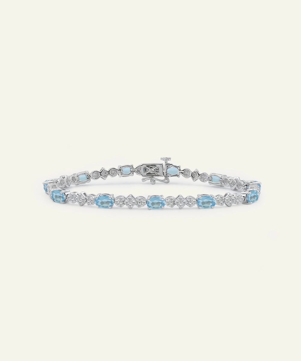 Silver bracelet with blue gemstones on a white background