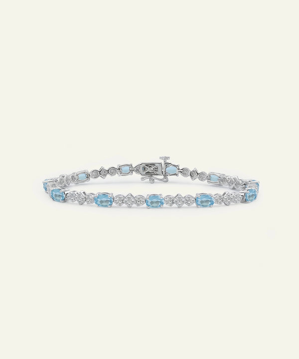 Silver bracelet with blue gemstones on a white background
