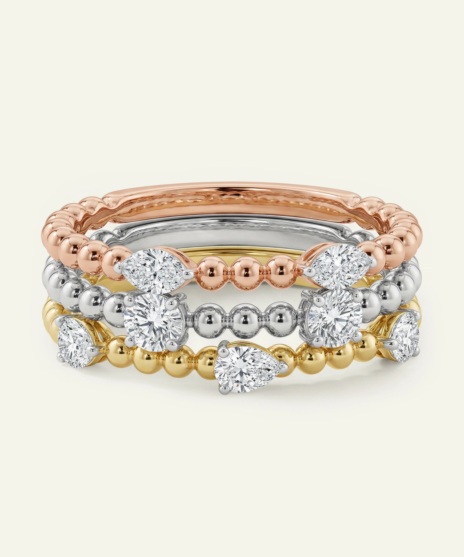 Set of three rings in rose gold, silver, and gold on a white background