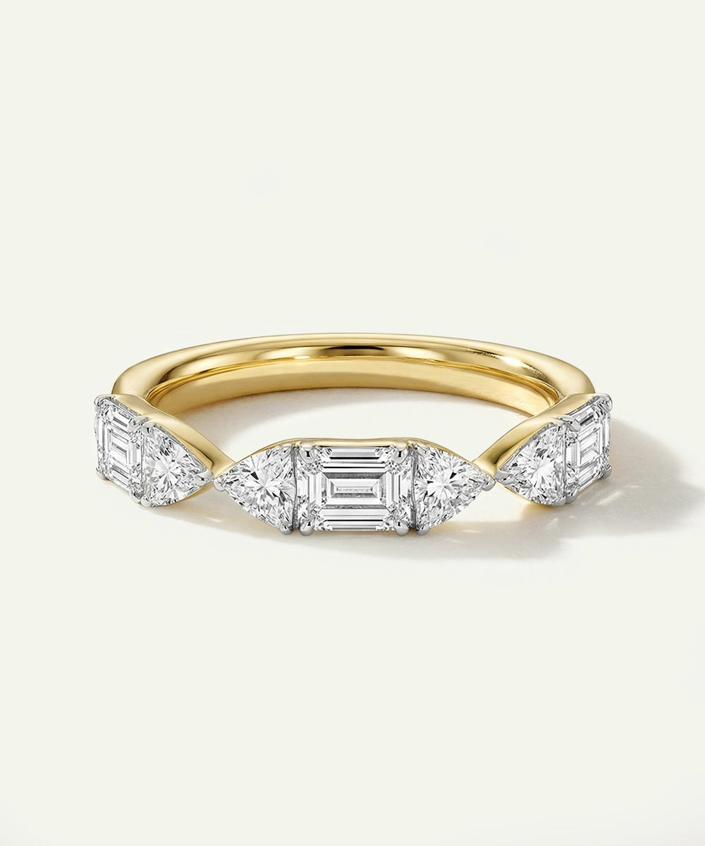 Gold ring with diamond stones on a white background