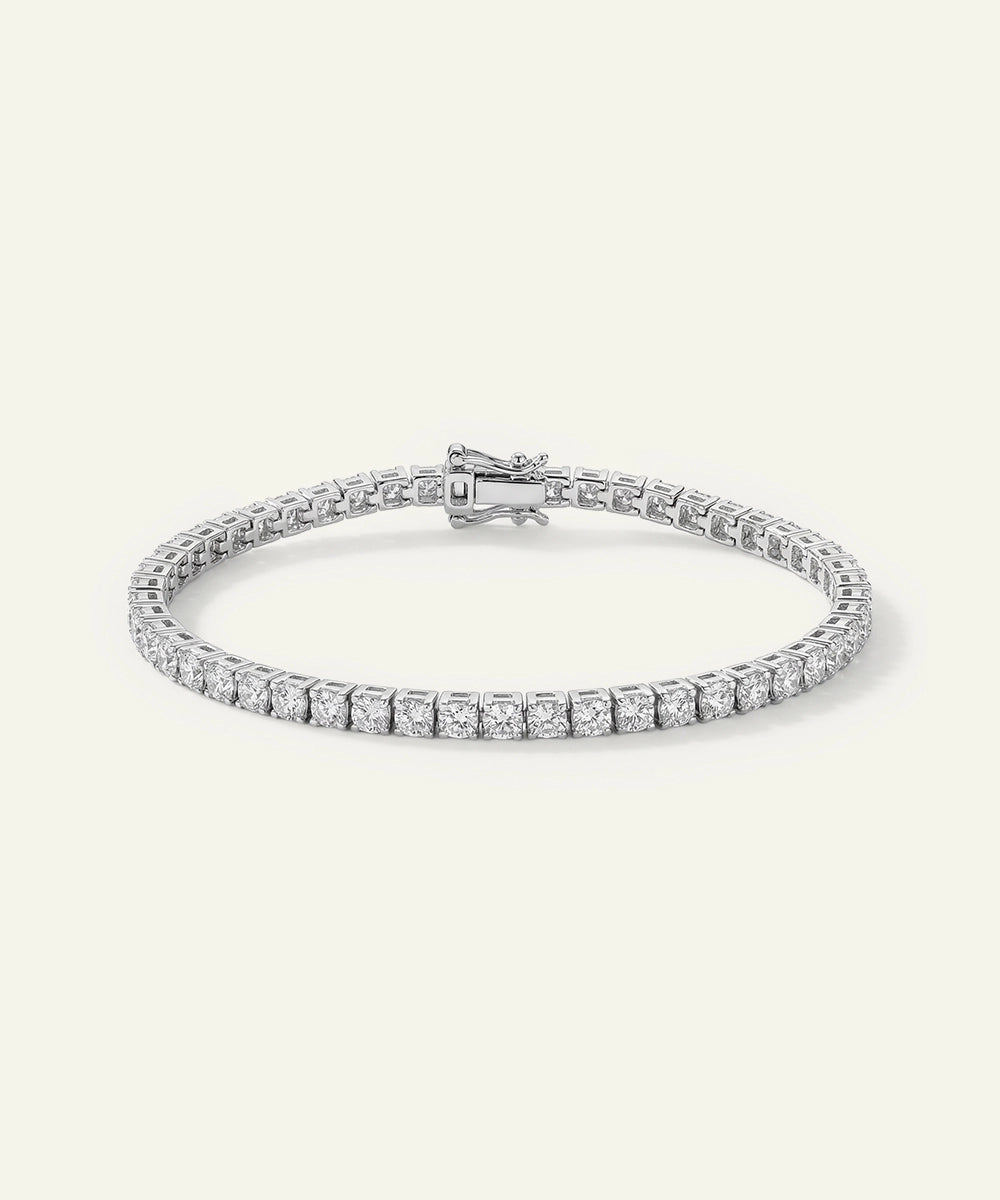 Silver bracelet with clear stones on a white background
