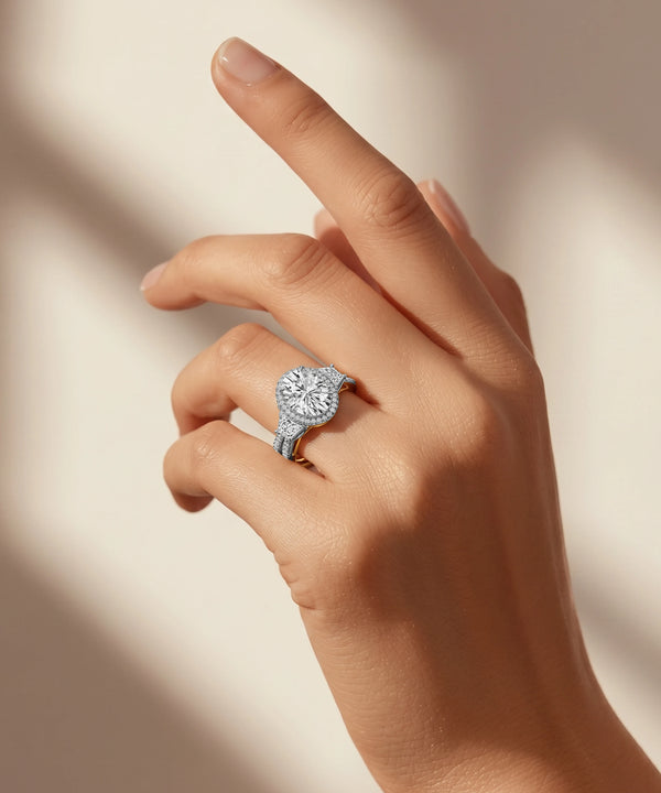 Hand wearing a diamond ring on a neutral background