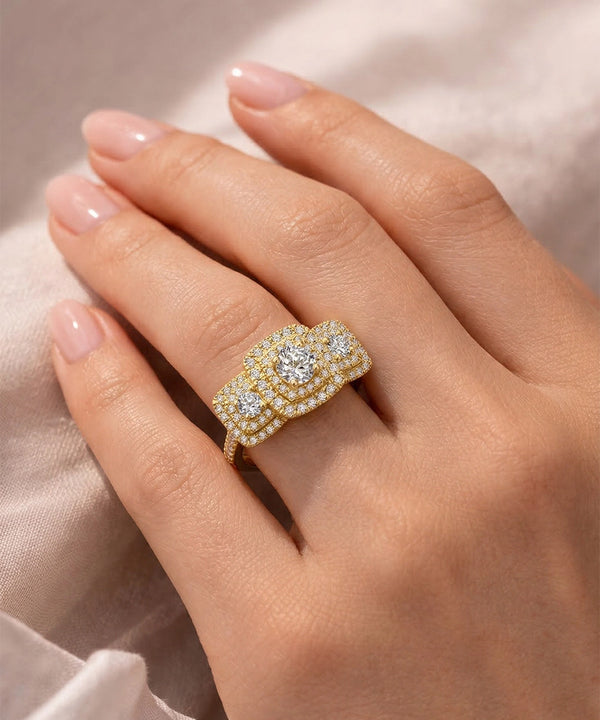 Gold ring with diamonds on a hand against a soft background