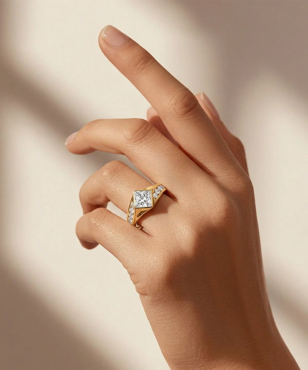 Hand wearing a gold ring with a diamond on a beige background