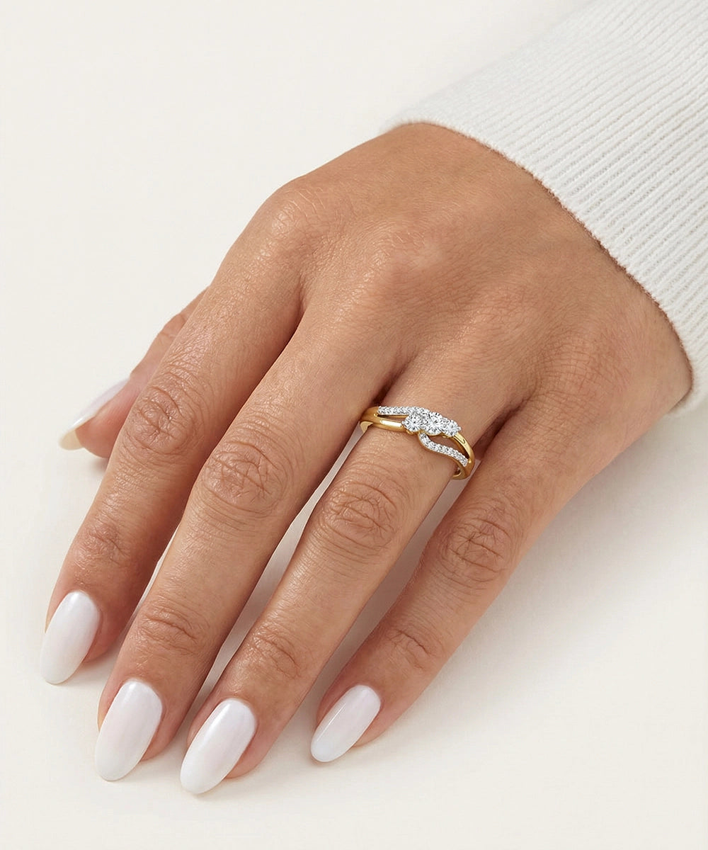 Hand wearing a gold ring with diamonds on a white background