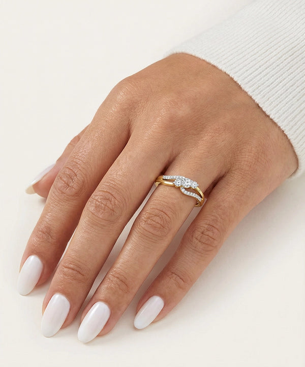 Hand wearing a gold ring with diamonds on a white background