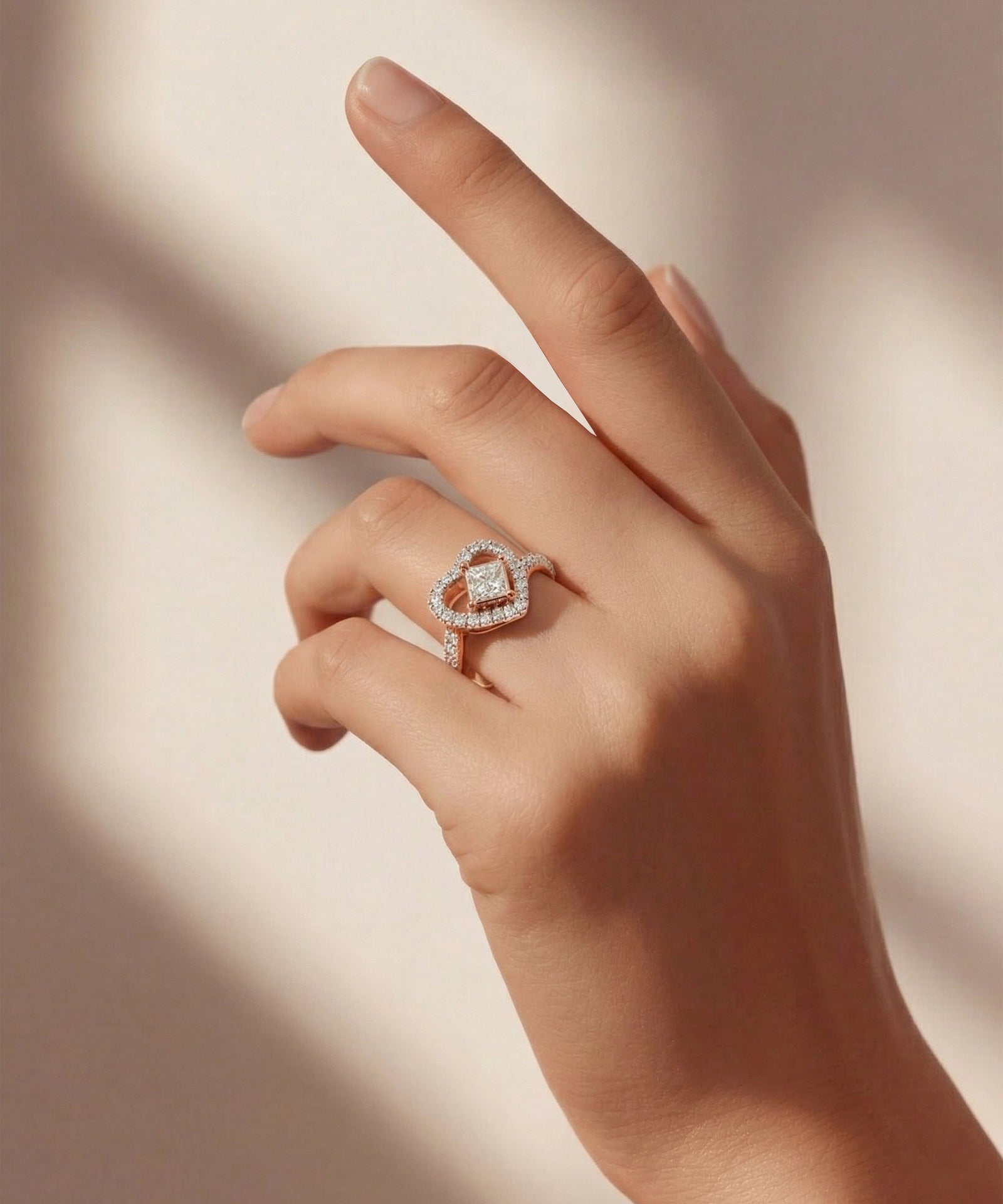 Hand wearing a diamond ring with a soft background