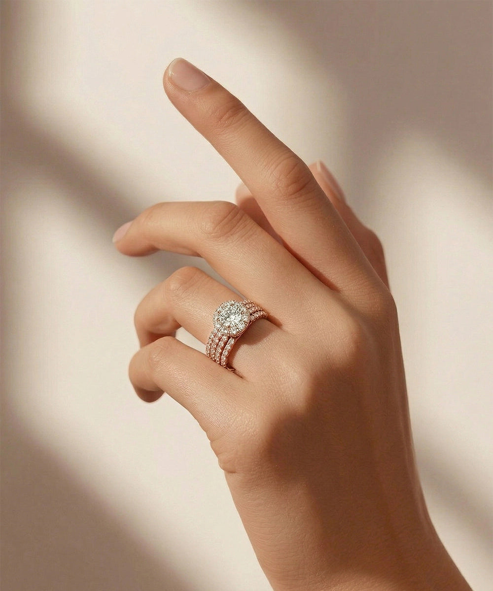 Hand wearing a rose gold ring with a diamond on a soft background