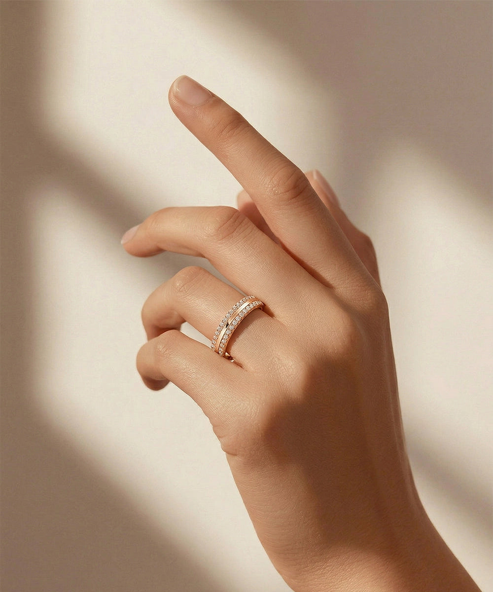 Hand wearing a ring with a diamond on a neutral background