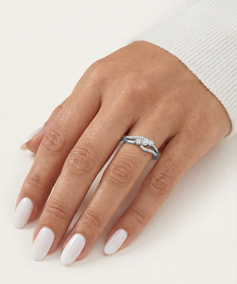 Hand wearing a silver ring with a diamond on a white background