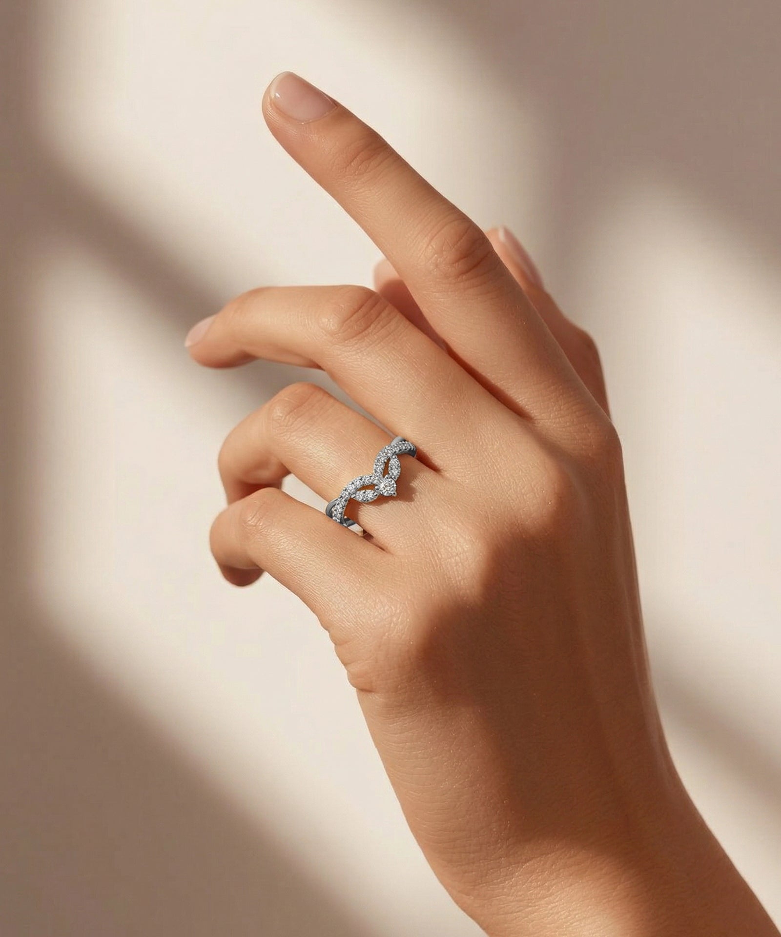 Hand wearing a ring with a soft background