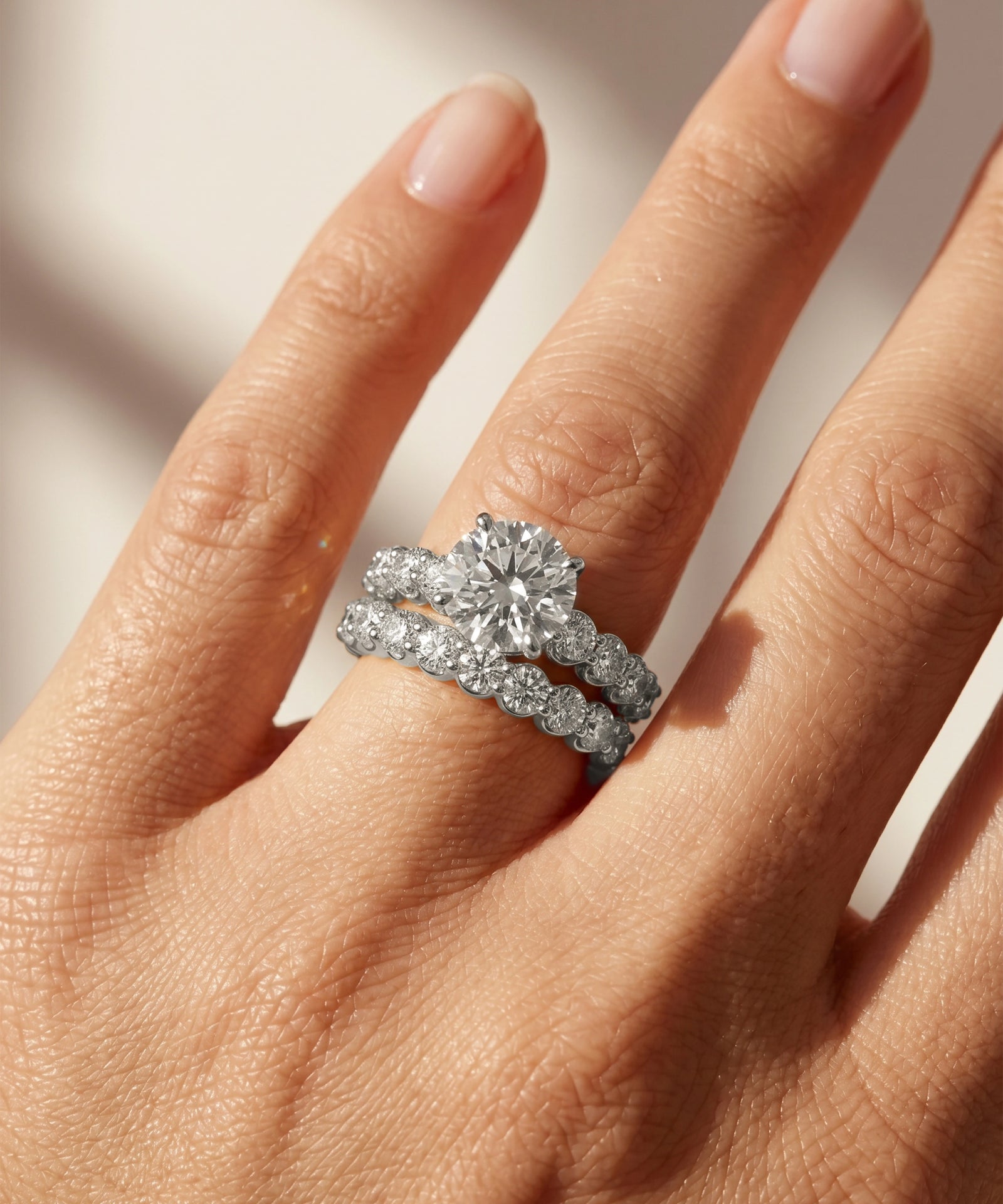 Diamond ring on a hand with a neutral background