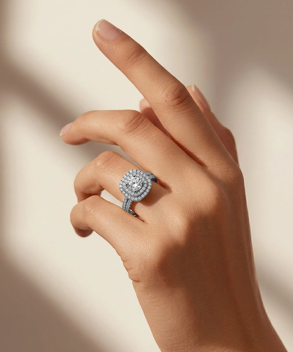 Hand wearing a diamond ring on a neutral background