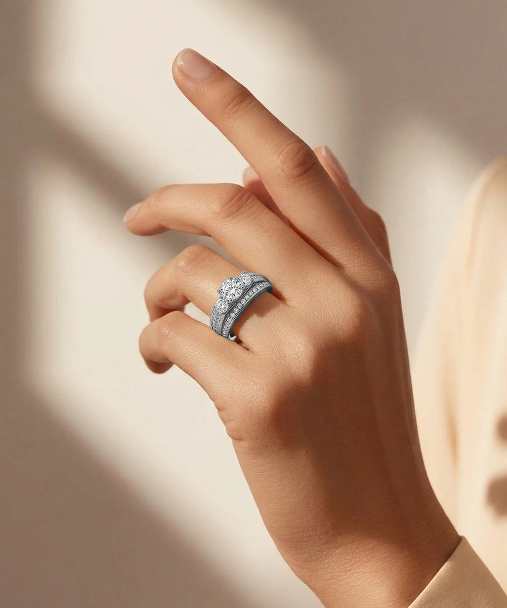 Hand wearing a silver ring with a diamond on a neutral background