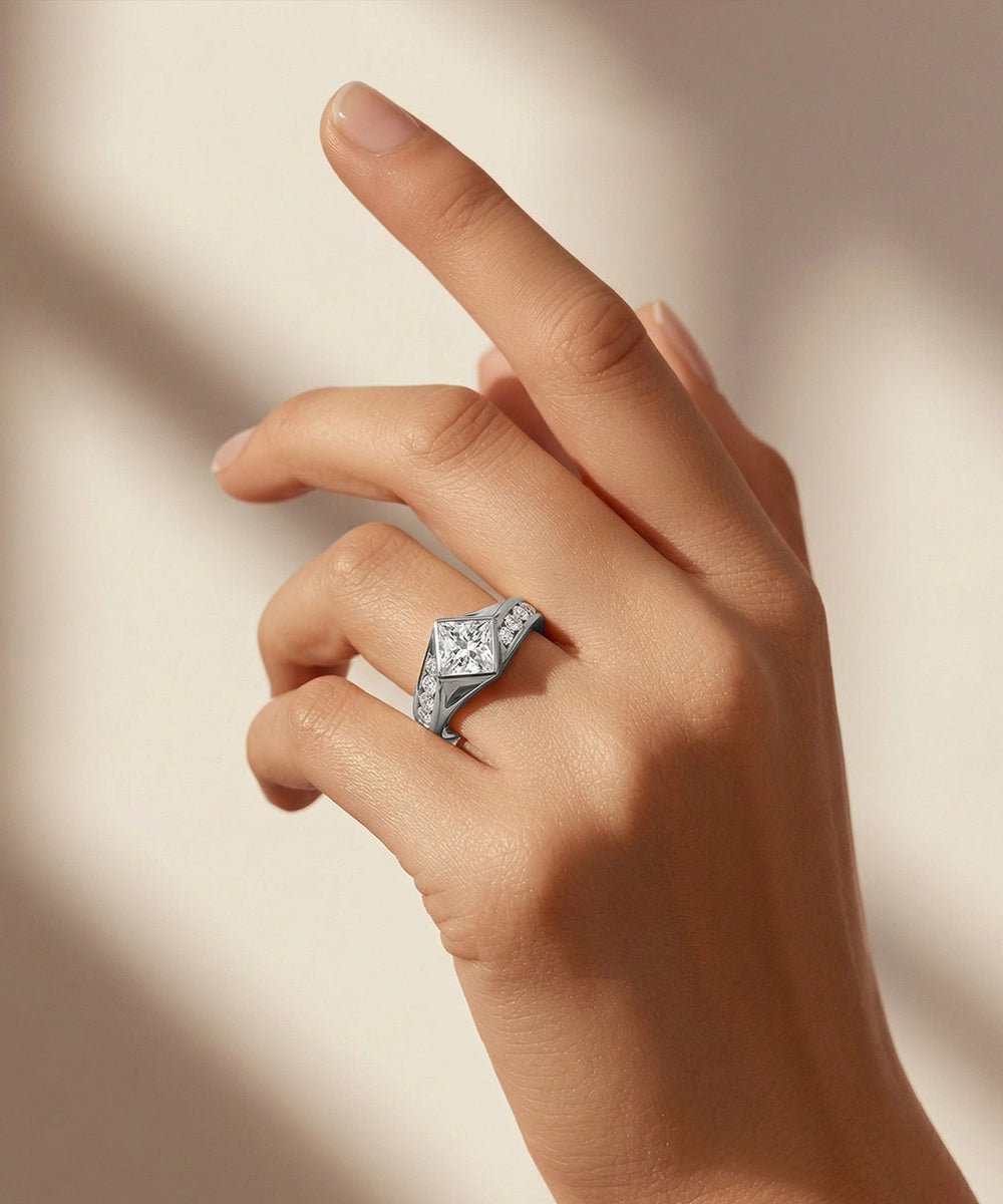 Hand wearing a diamond ring on a neutral background