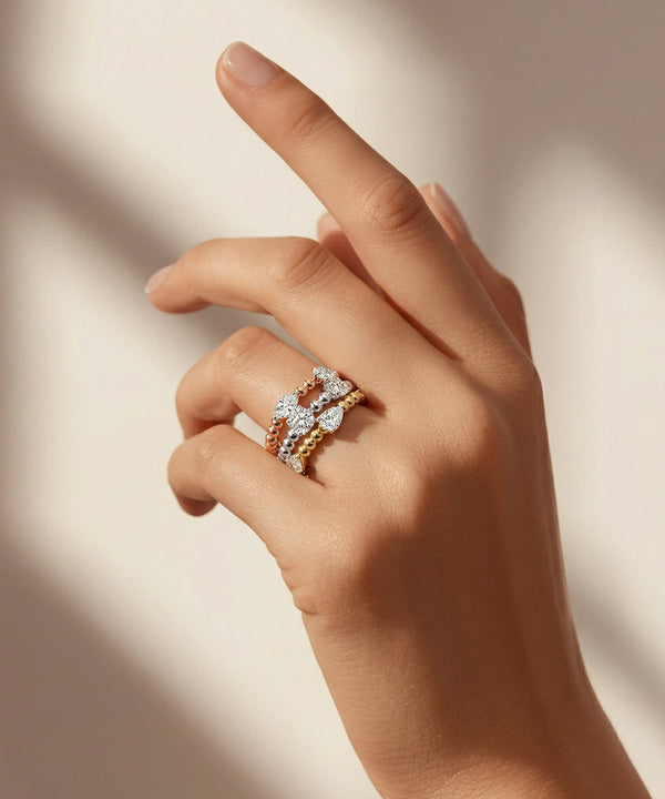 Hand wearing a ring with a neutral background