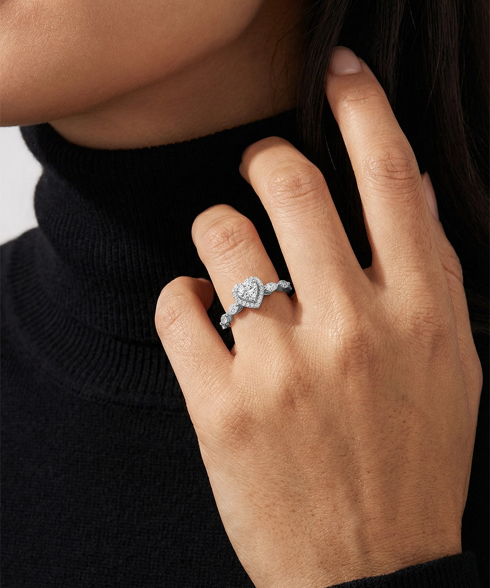 Hand wearing a diamond ring with a black turtleneck sweater