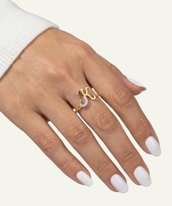 Hand wearing a gold ring with a diamond on a white background